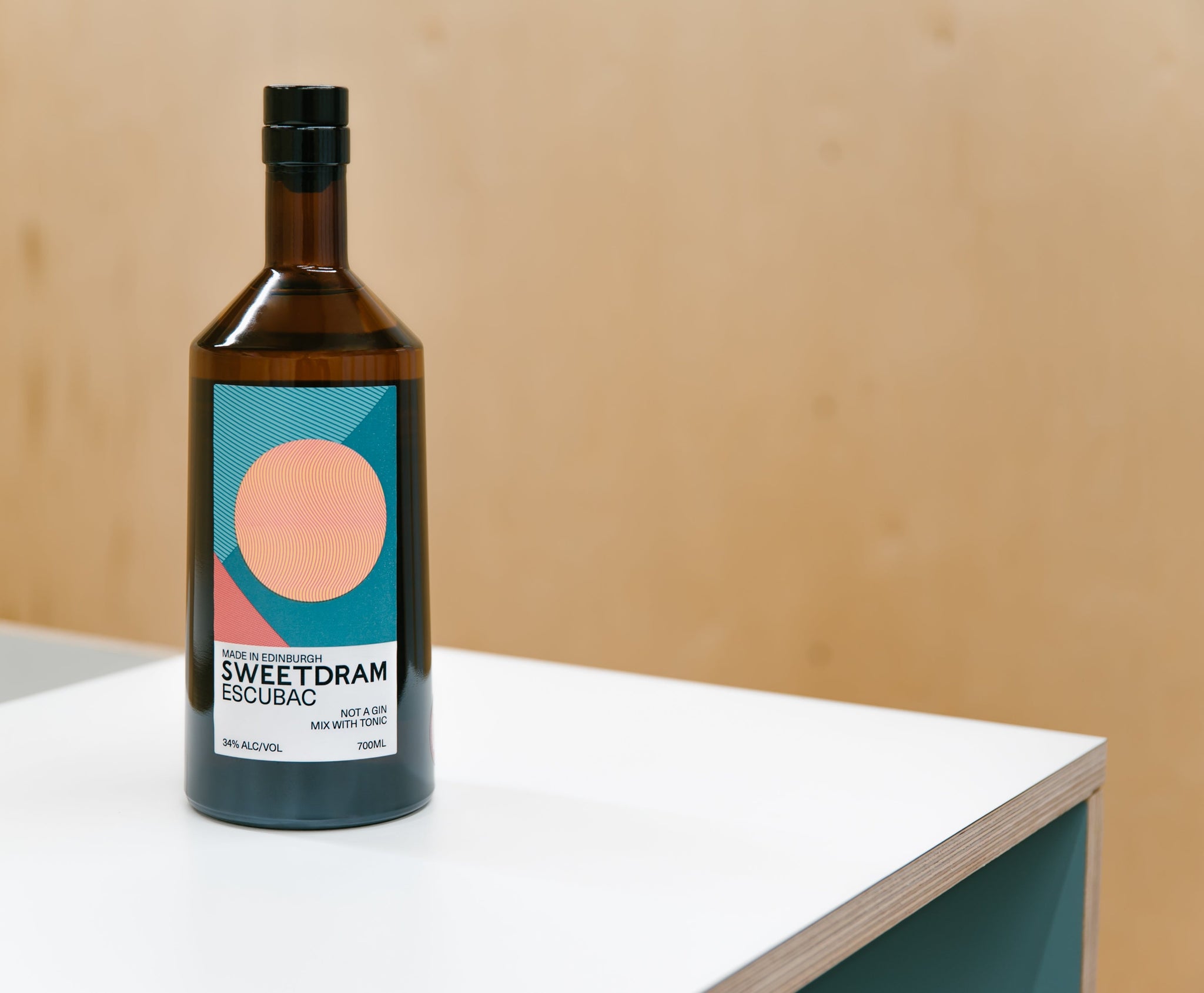 Bottle of Sweetdram Escubac on white table in Sweetdram bar area.