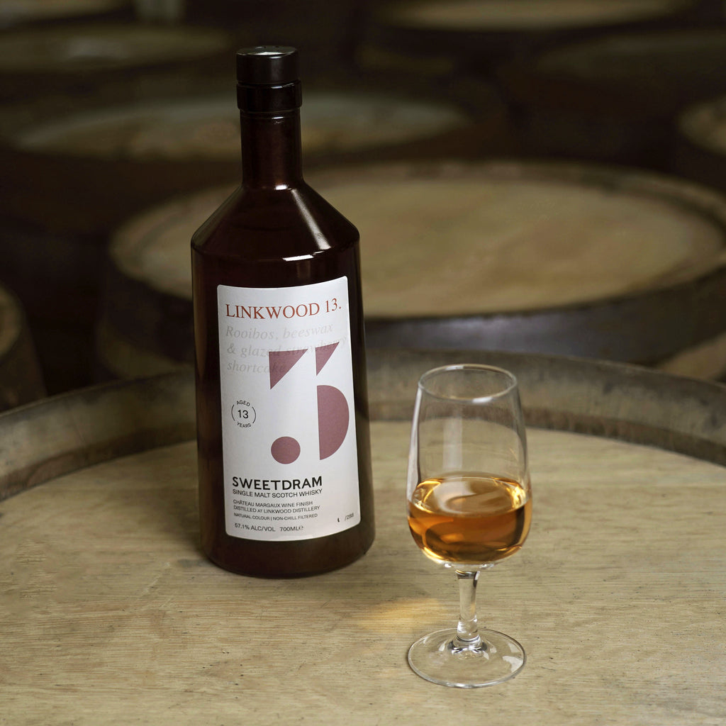750ml bottle of Linkwood 14-year-old single-cask Whisky sitting on a cask, with a dram in tasting glass.