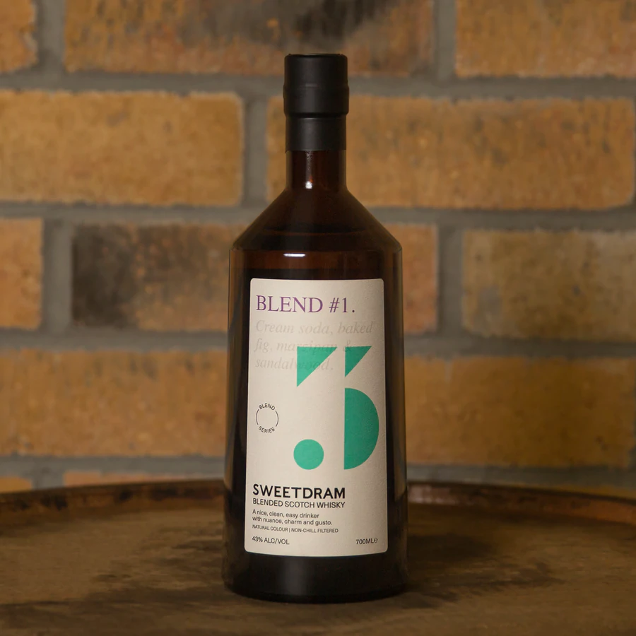 Close up of Blend #1 brown 700ml bottle on cask in Sweetdram distillery against brick wall.